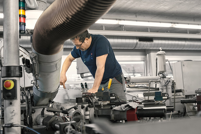 Employee at work on big maschine