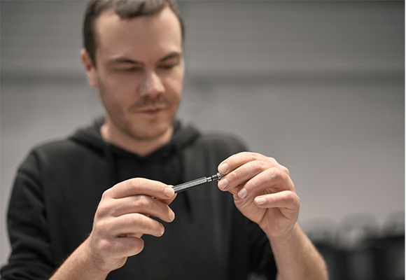 Employee inspecting metal part