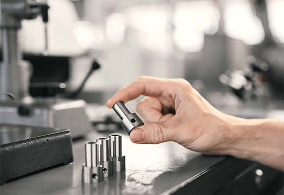 Close up of hand grabbing metal part